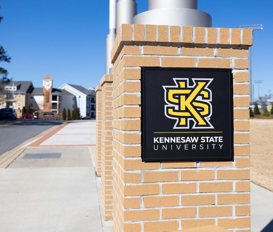 Photo of a KSU sign on the side a brick barrier