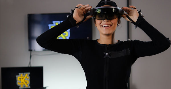 A student engages with a virtual reality headset, showcasing immersive technology at the College of Computing and Software Engineering.