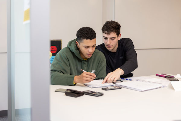 two students working together at a table