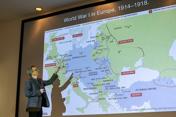 professor explaining locations on a world war one map of europe