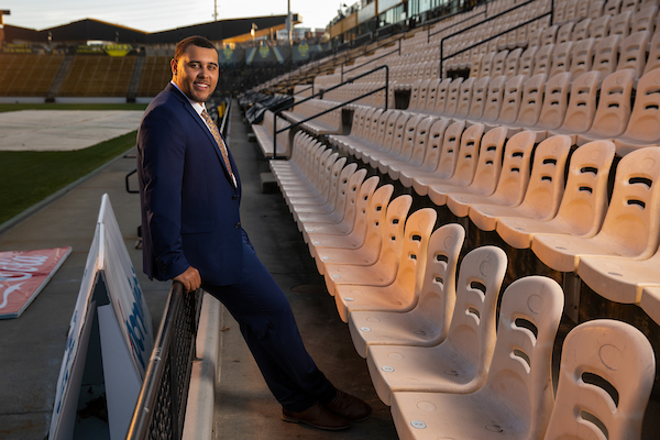 manager wearing suit in empty stadium