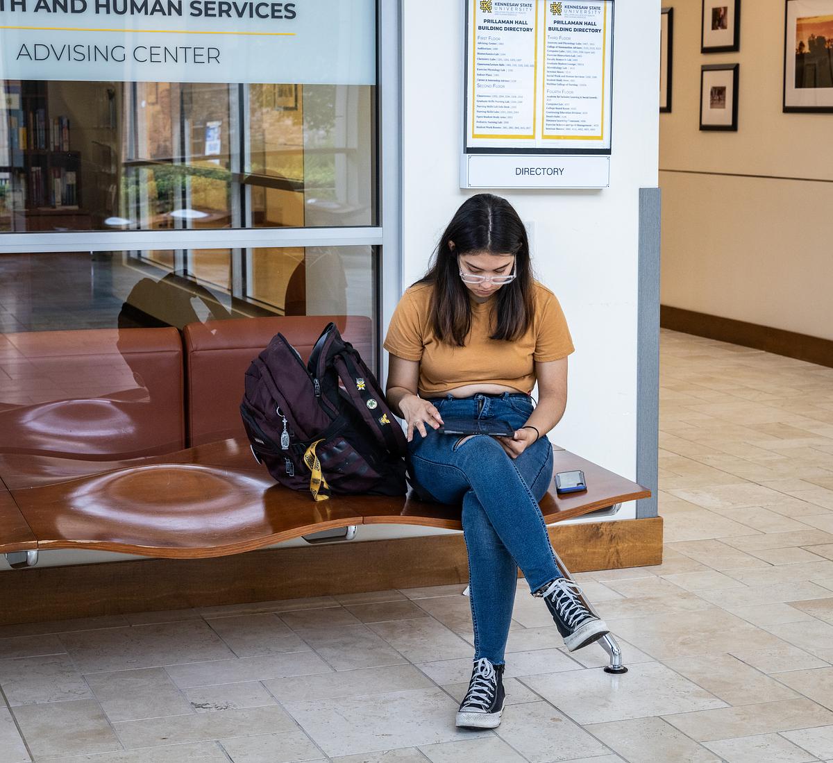 girl sitting outside advising office