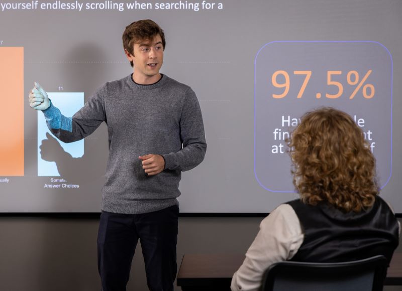 A man presents to an audience, engaging them with his speech and visual aids.