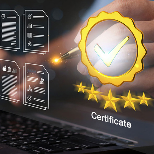 A hand is hovering over a laptop keyboard, holding a pen that is pointing at a golden seal with a checkmark inside. Behind the seal are several documents and five golden stars, with the word &quot;Certificate&quot; displayed below.