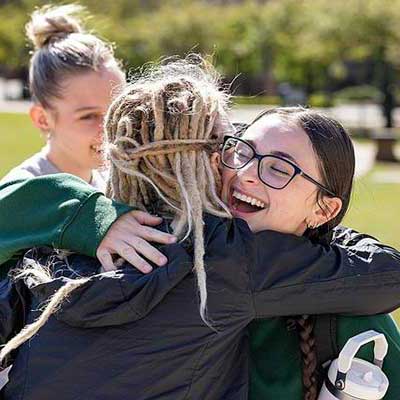 students hugging