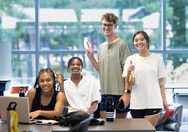 group of students waving to the camera