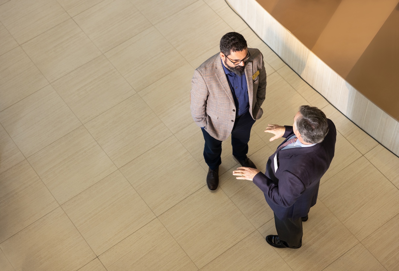 two business men talking at the center.