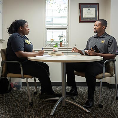 student success coach having a one-on-one support conversation with a student.