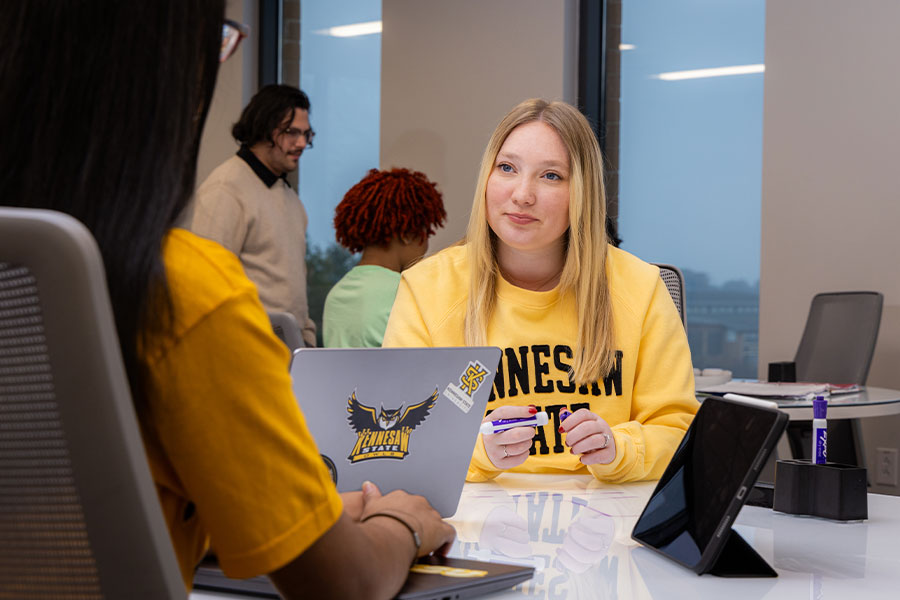 ksu students at the smart center studying at a table.