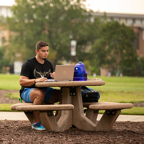 ksu student using their laptop for a virtual appointment.