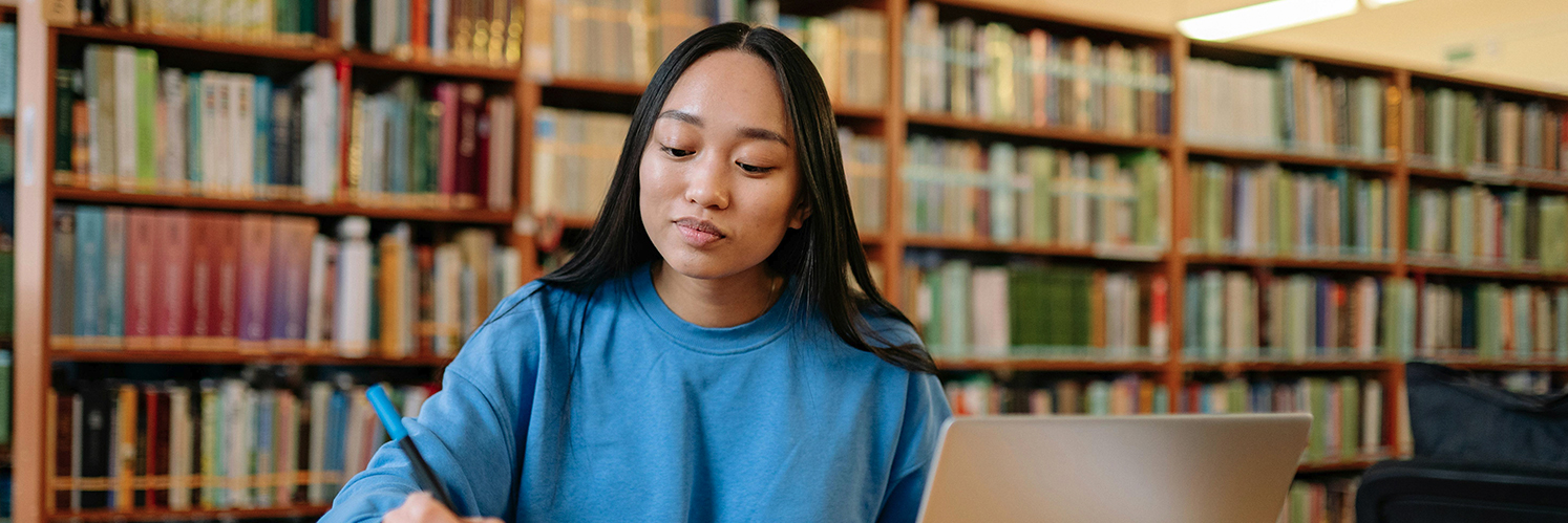 female student in library smiling
