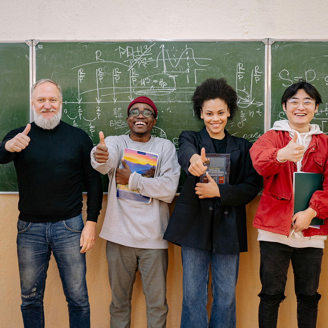 male teacher with students smiling