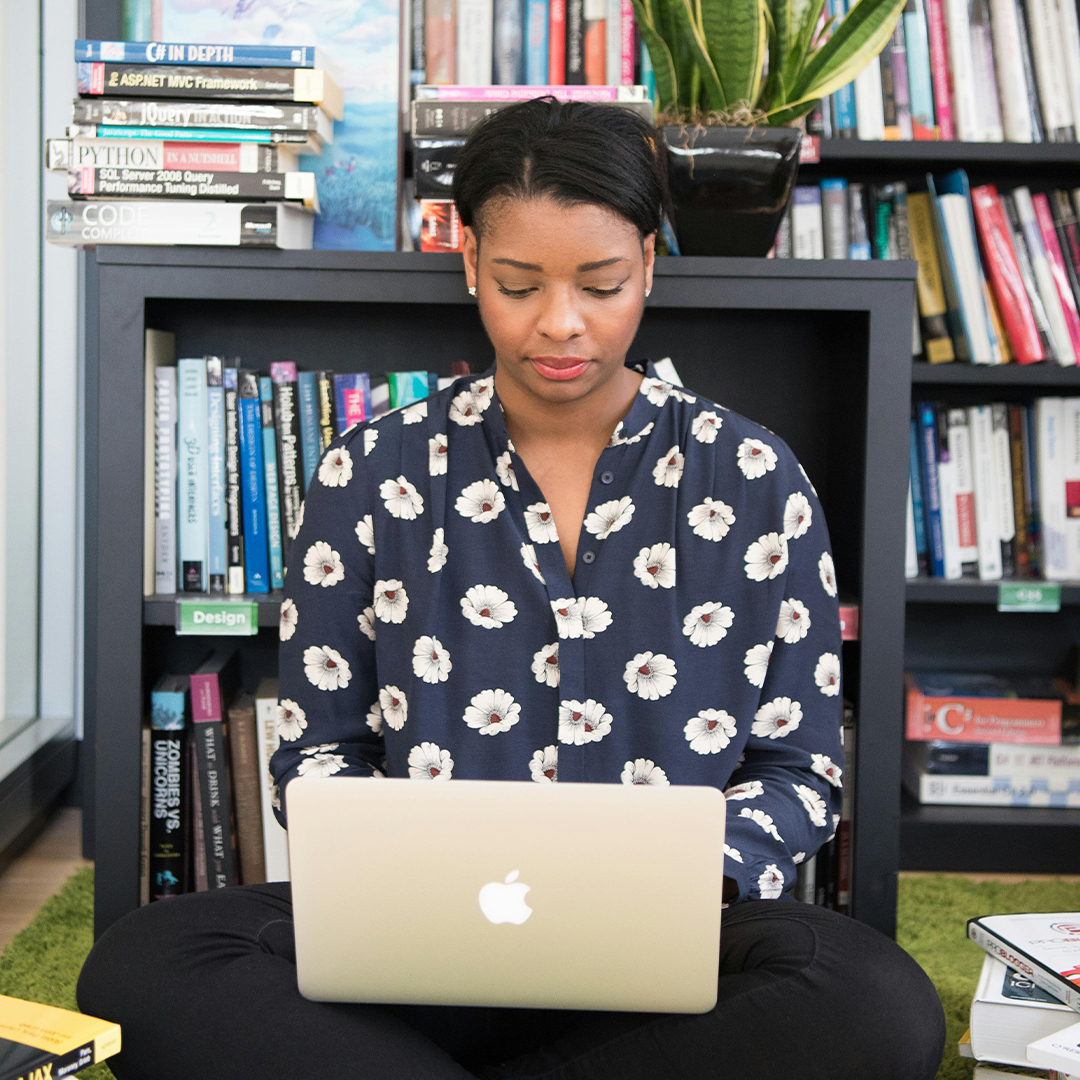 female on computer in library room