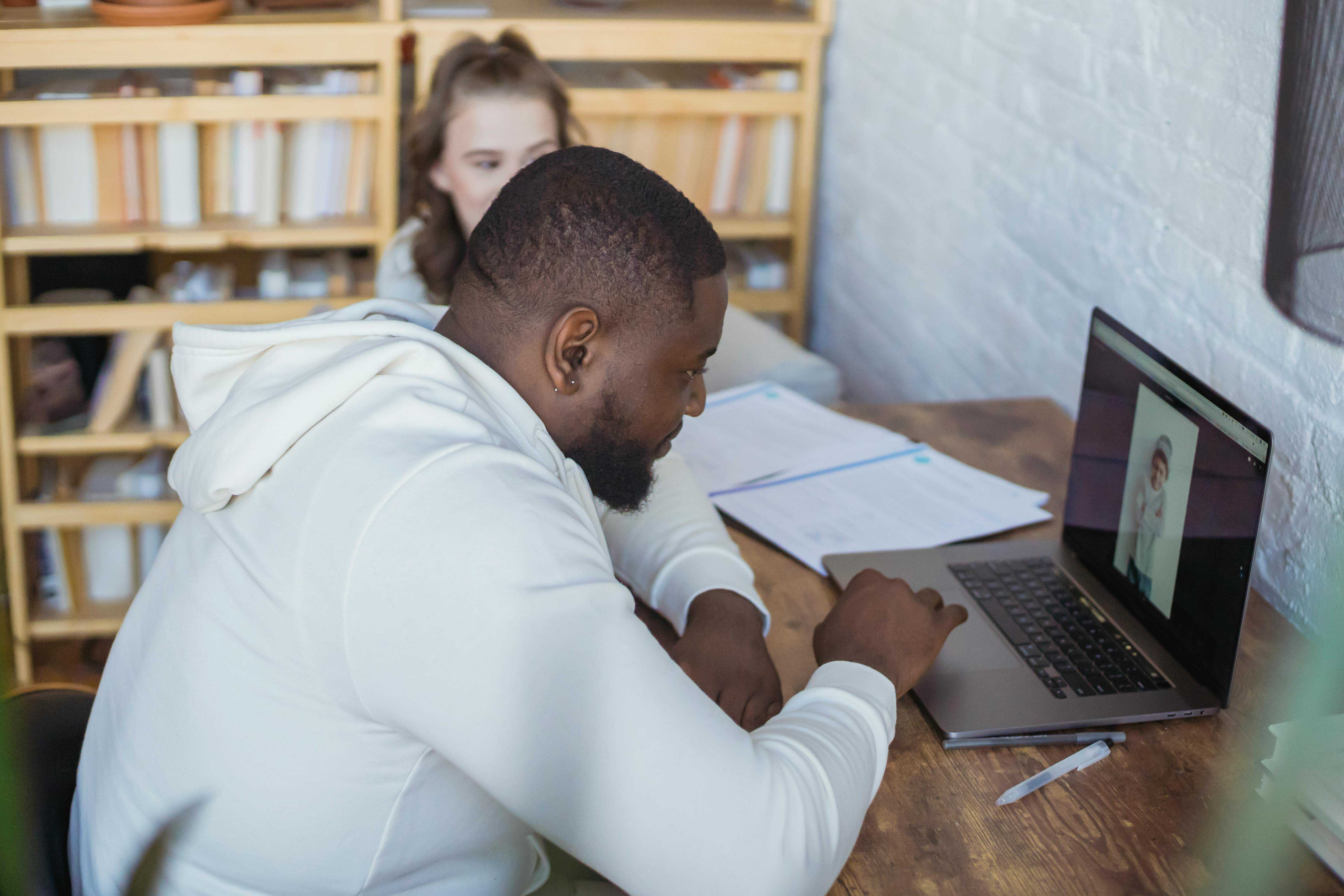 male at computer looking at photoshop image on laptop