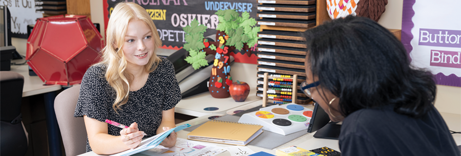 Female student learns from teacher mentor about math education