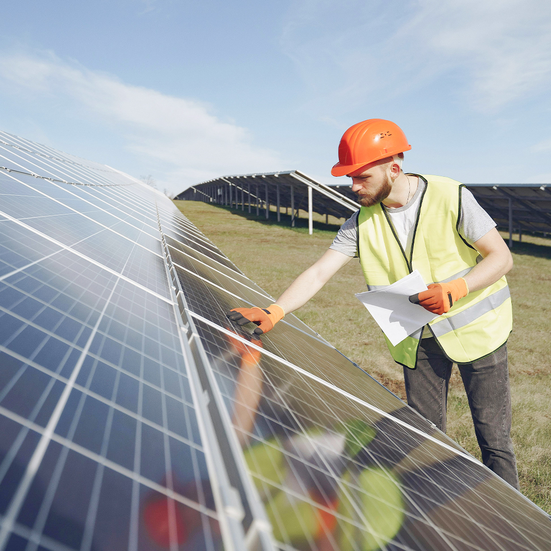 environmental engineer working on solar panel outside