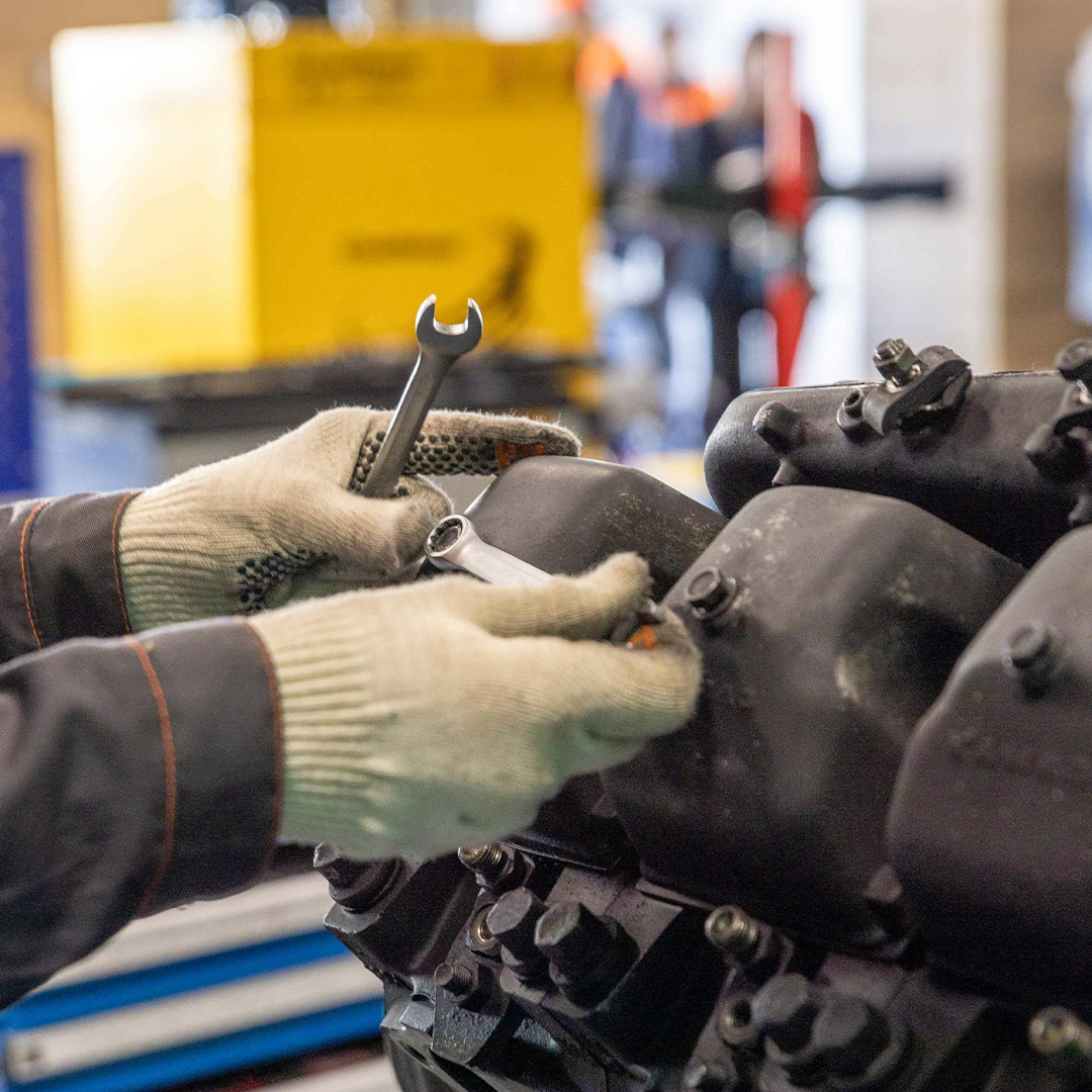 Close up of hands of a mechanical engineer wearing gloves