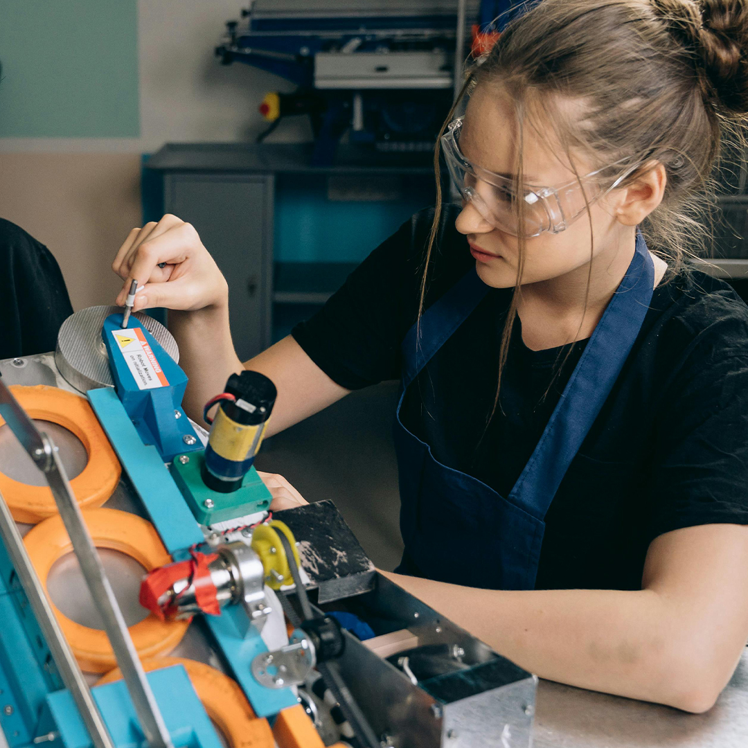 female machatronics engineer working on building a robot