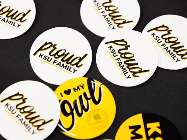 Photo of decorate buttons that say 'proud owl family'
