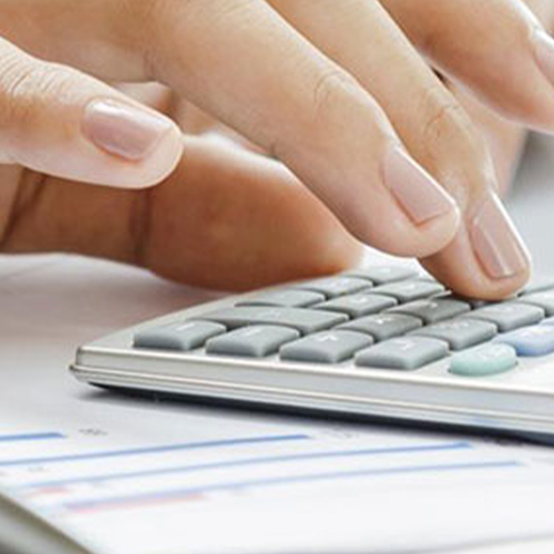 close up of female hand working on calculator