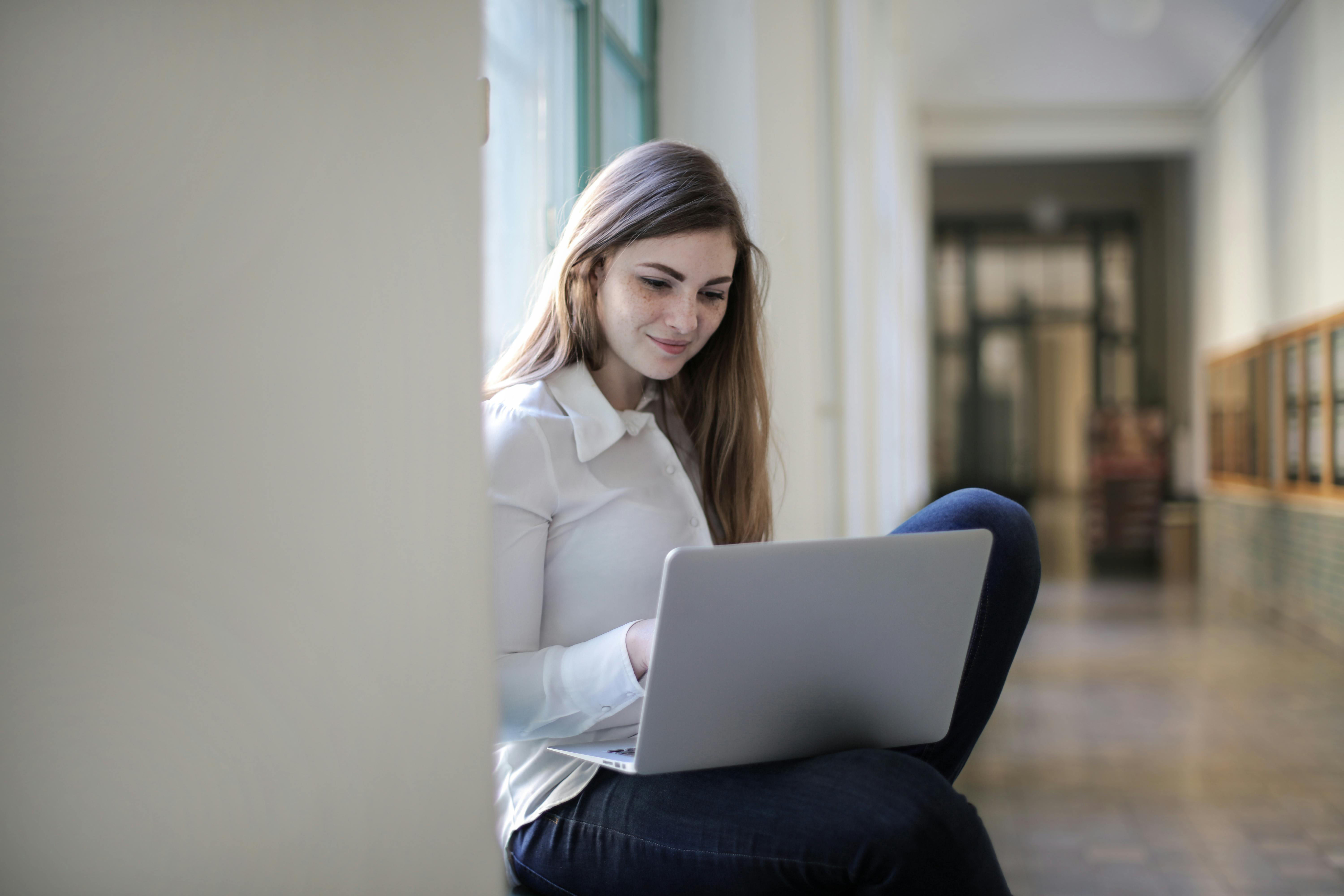 female student smiling as she sits