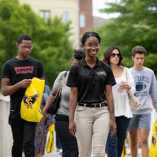 tour guide showing the campus to high school students.