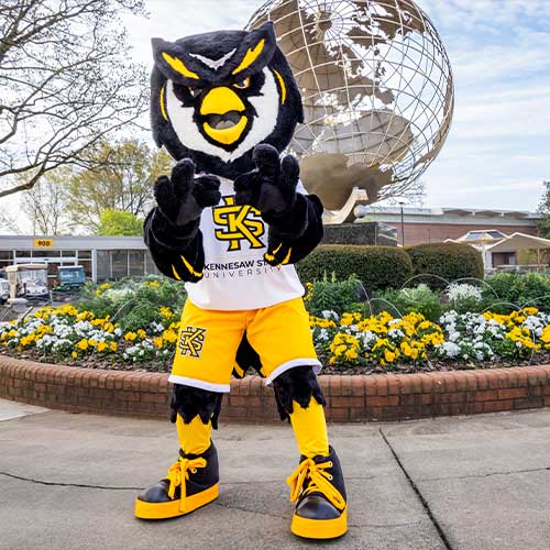 scrappy at the marietta campus posing near the globe.