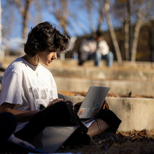 Highschool student studying on laptop