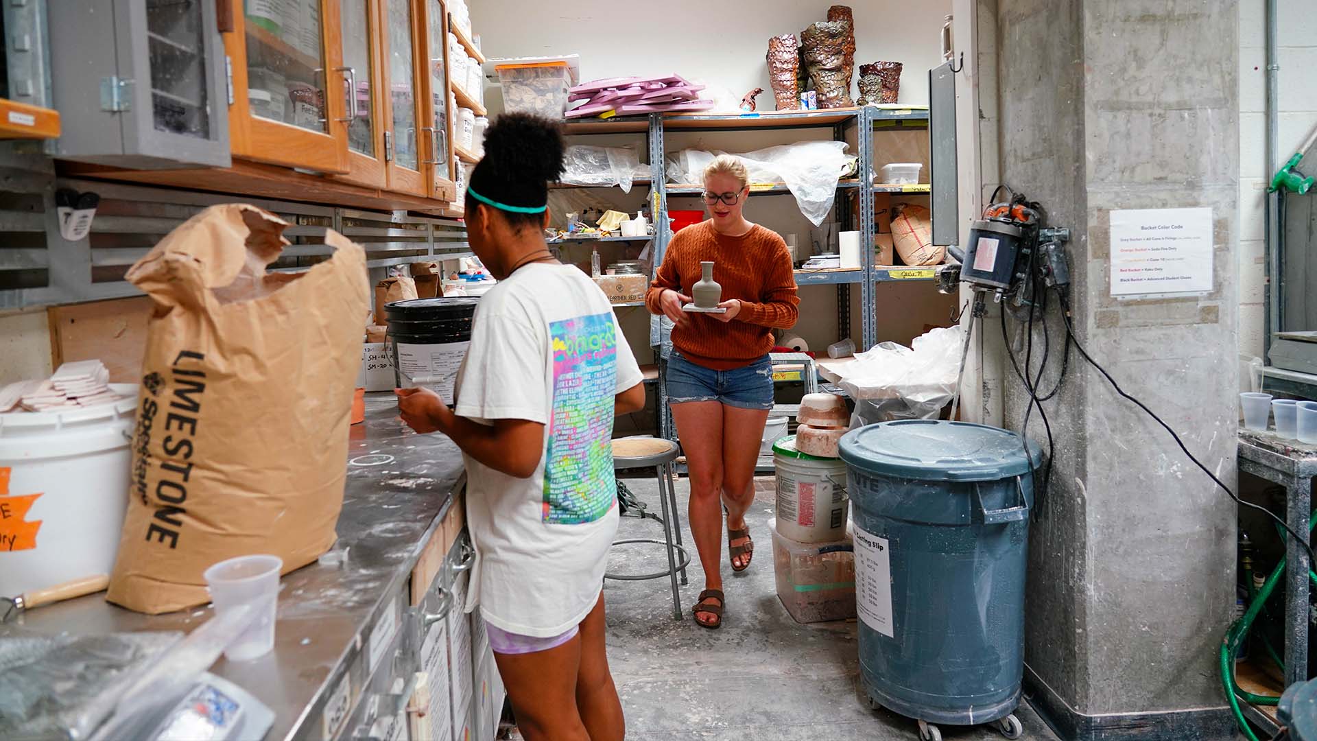  / Ceramics students working in glaze room. 