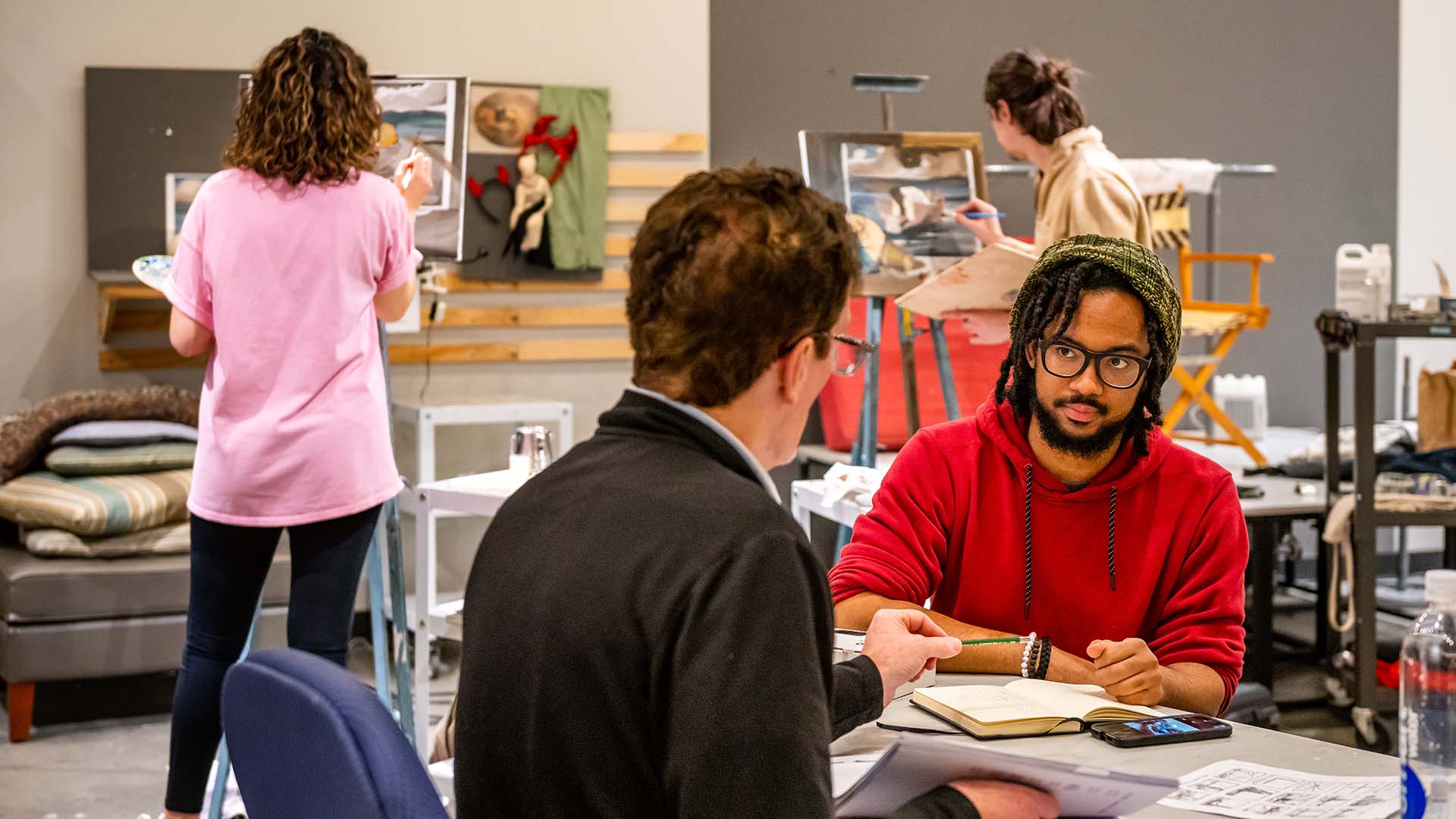  / Student discussing project with Professor Joe Remillard in painting studio. 