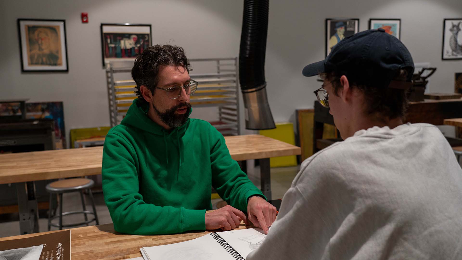  / Professor Joe Karg reviewing a prospective student's portfolio in our printmaking studio.