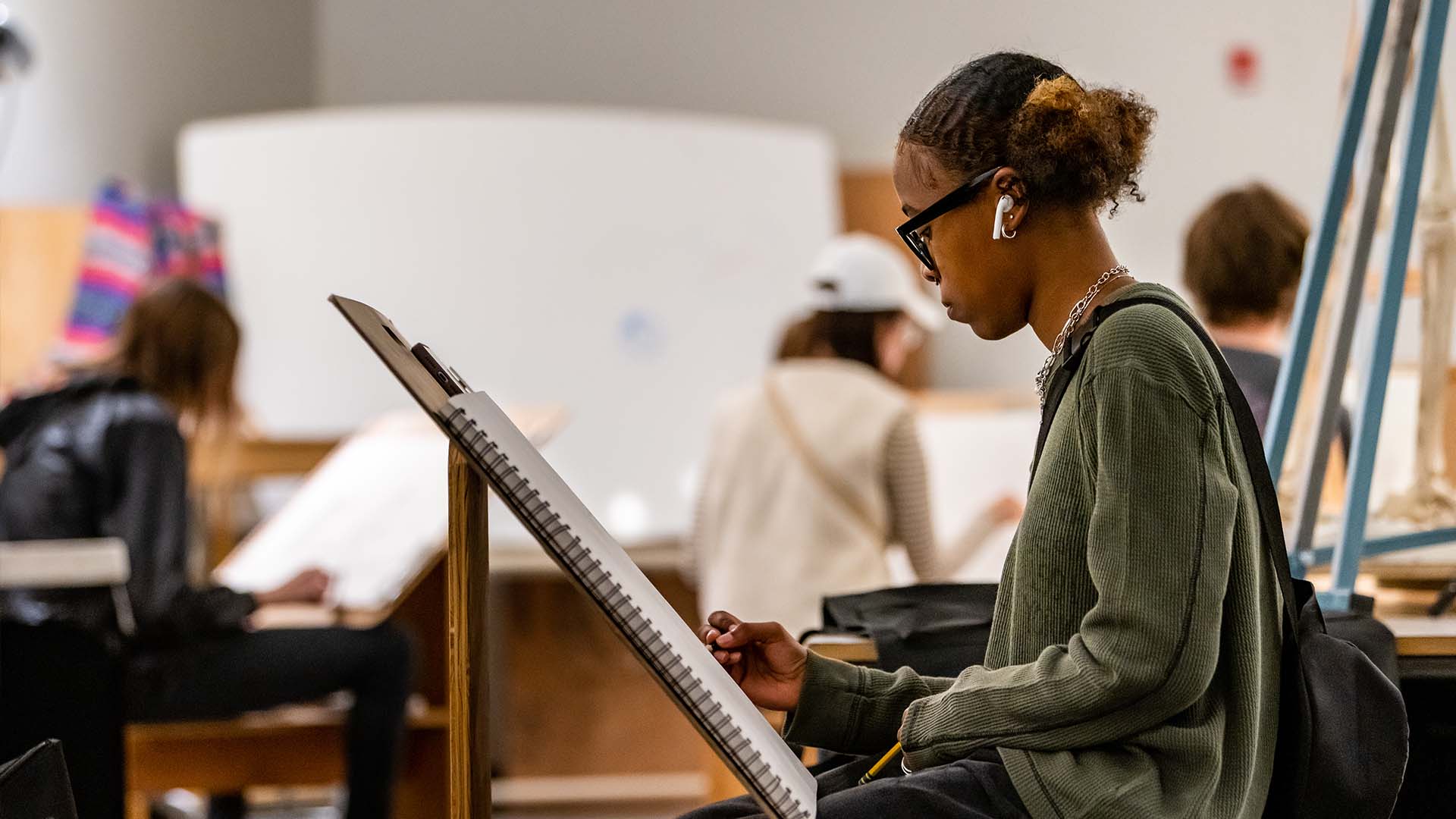  / Drawing student working on drawing in drawing studio. 