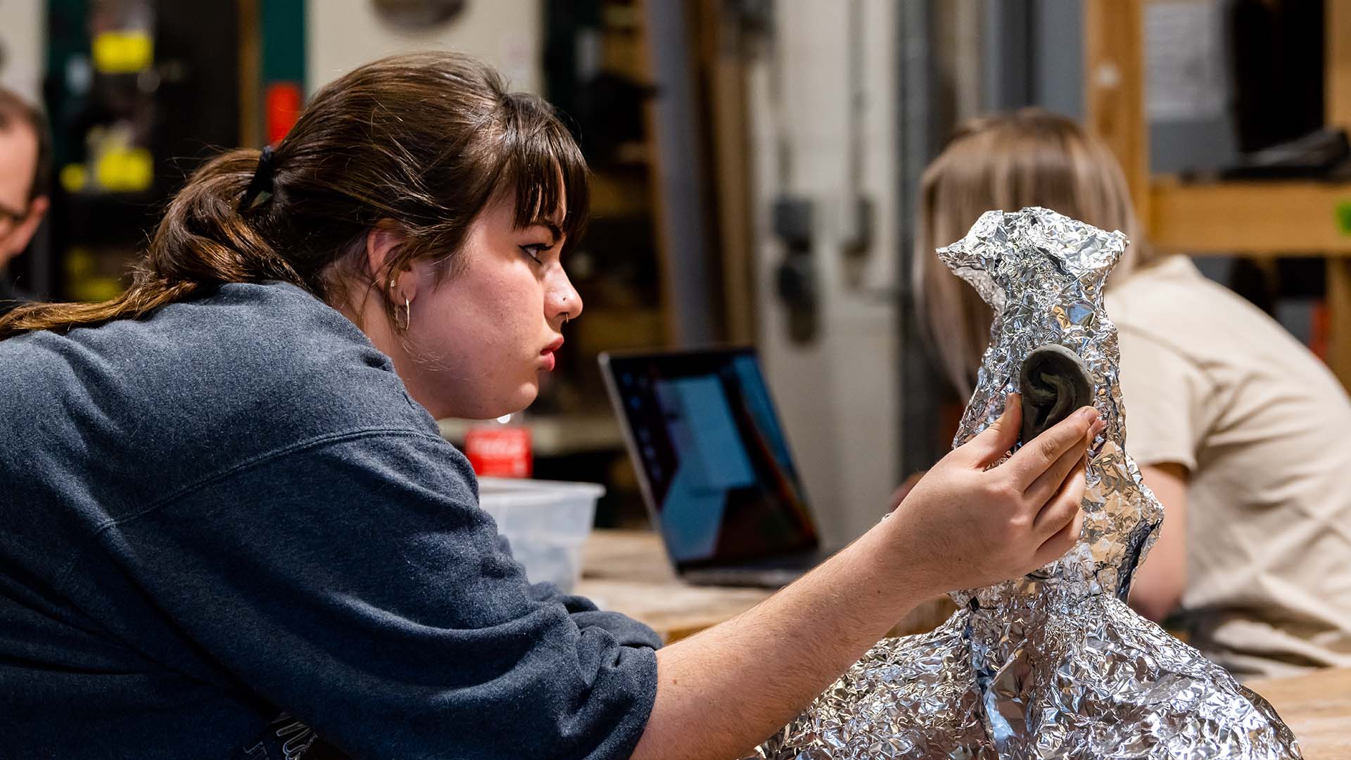  / Sculpture student working on her model in sculpture studio. 