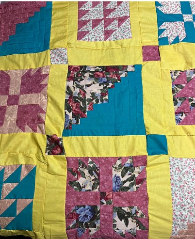Bear Paw", "Log Cabin", and "Birds in the Air / This quilt features the "Bear Paw", "Log Cabin", and "Birds in the Air" patterns and was made following the 6th through 8th grade lesson plan instructions.