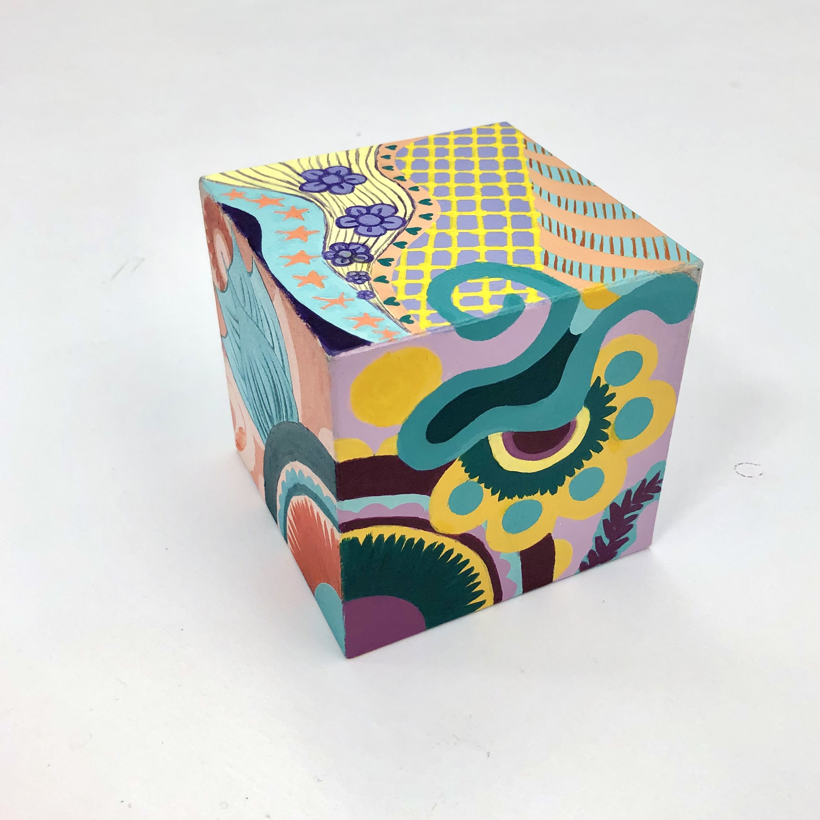 Aman Kaur / Aman Kaur, "Color Scheme Cube Design" acrylic paint and paint marker on 3" craft cube. The goal was to create a continuous, ongoing design while presenting a different one of the 6 color schemes studied in class. 