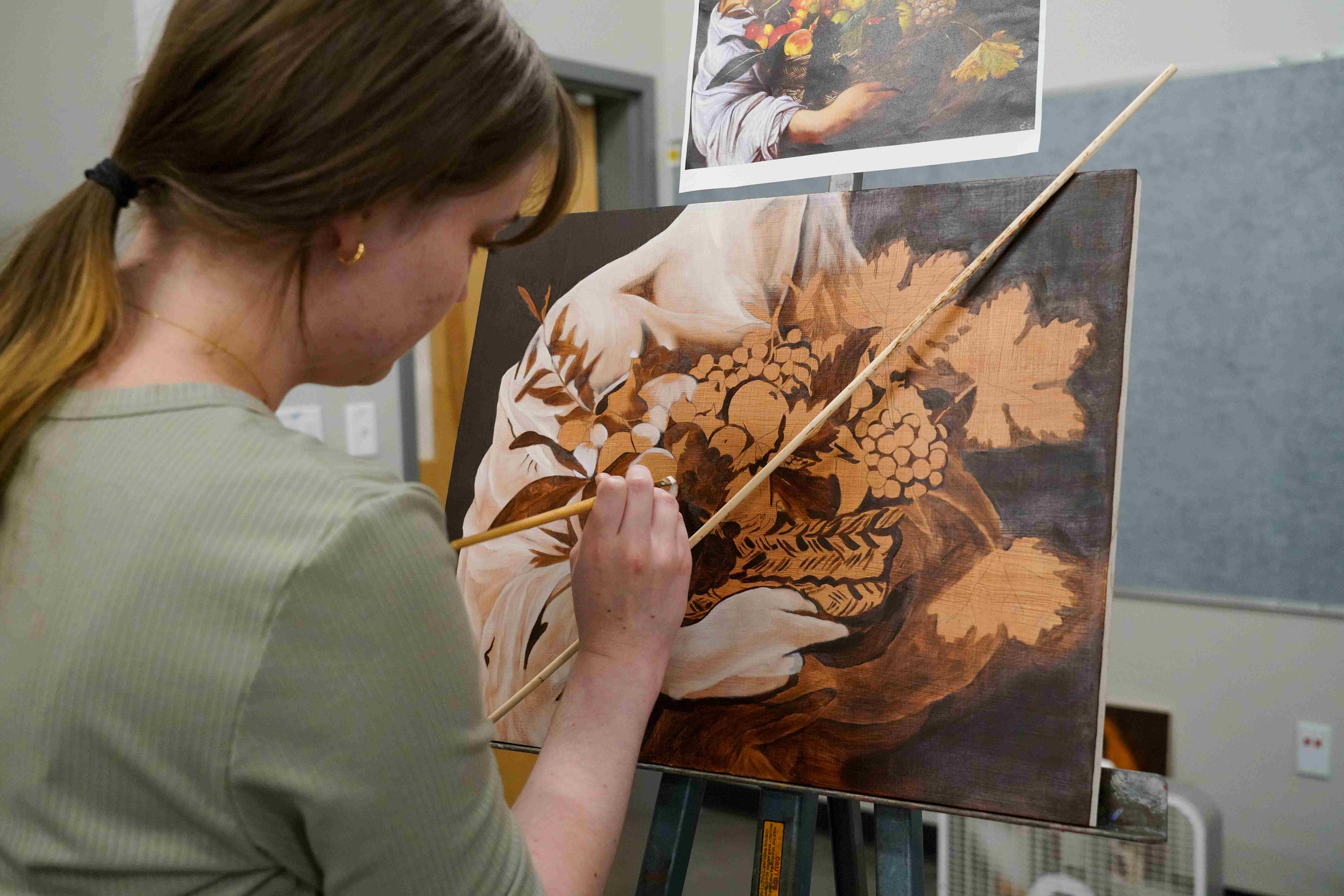  / Student working on painting using historical painting practices. 