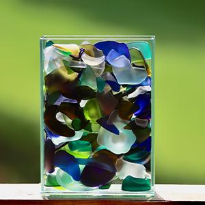  / Shards of Hope (2025). Sculpture of tumbled glass in a rectangular vase 