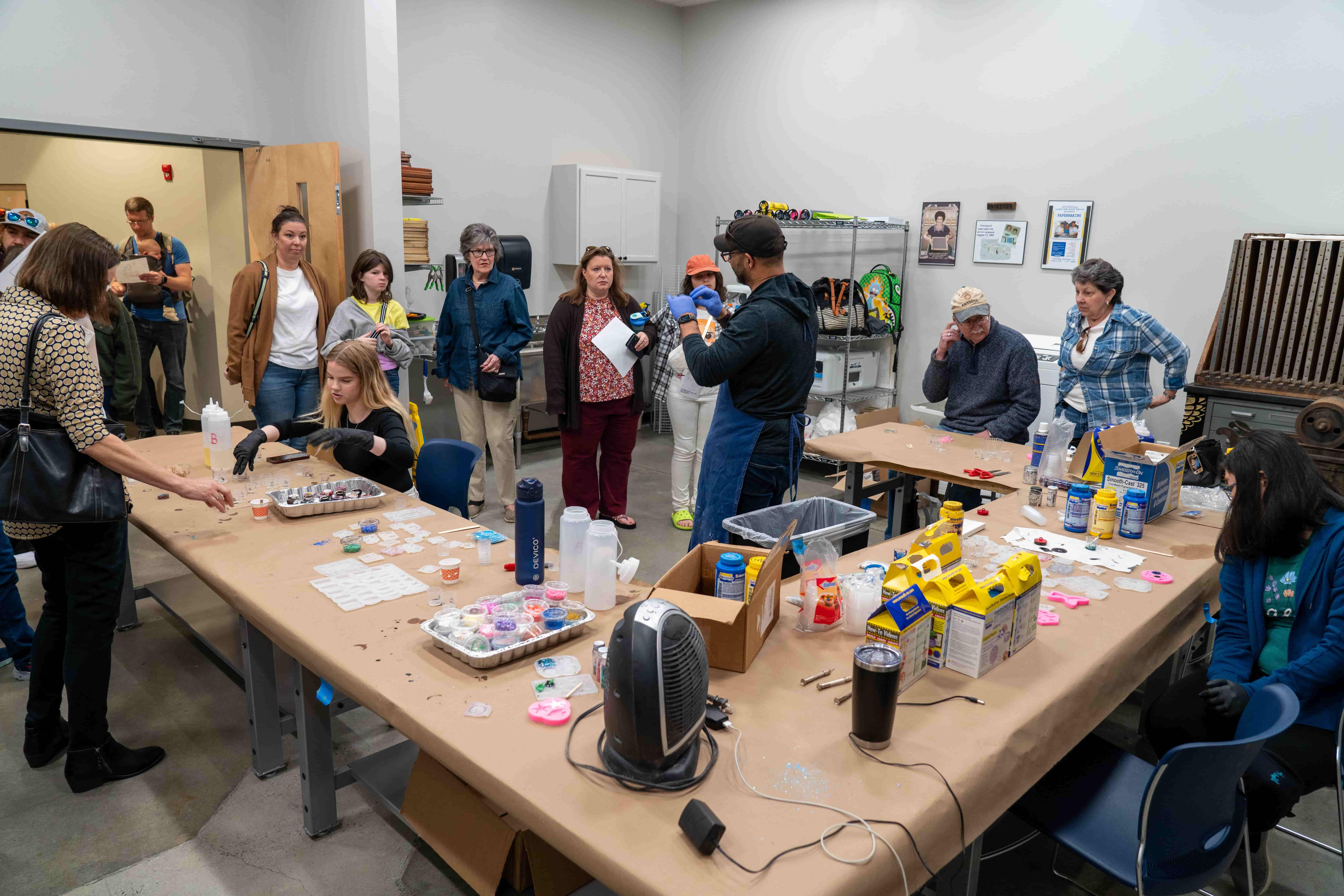 / K-12 students and parents creating quick set resin art.