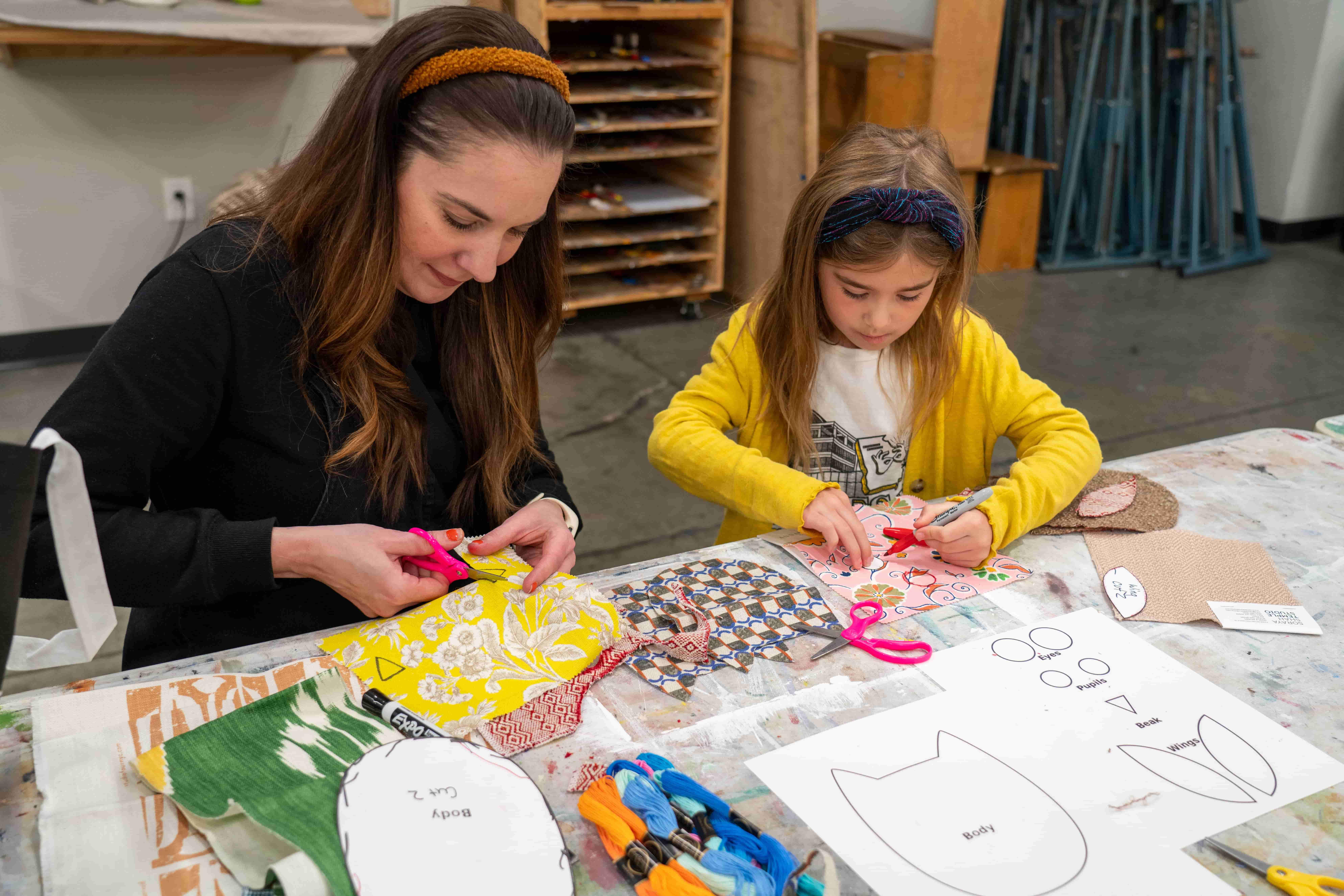 / Mother and daughter creating stuffed owls.