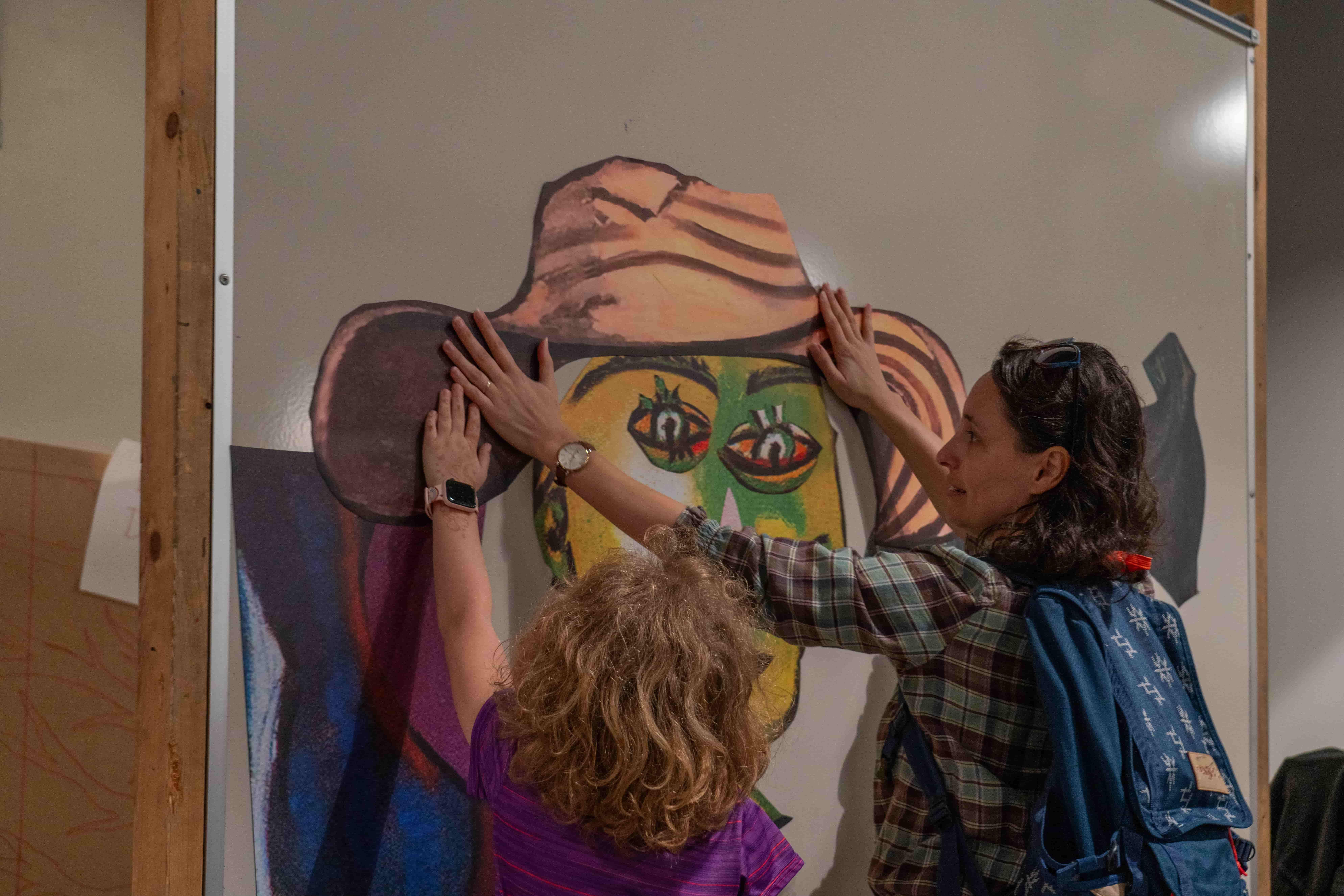 / Mother and daughter arranging giant magnets of various Picasso painting body parts to create a new creation.