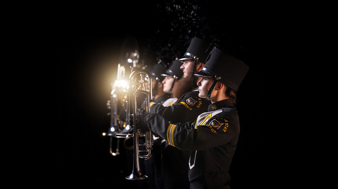 band students in front of dramatic black landscape
