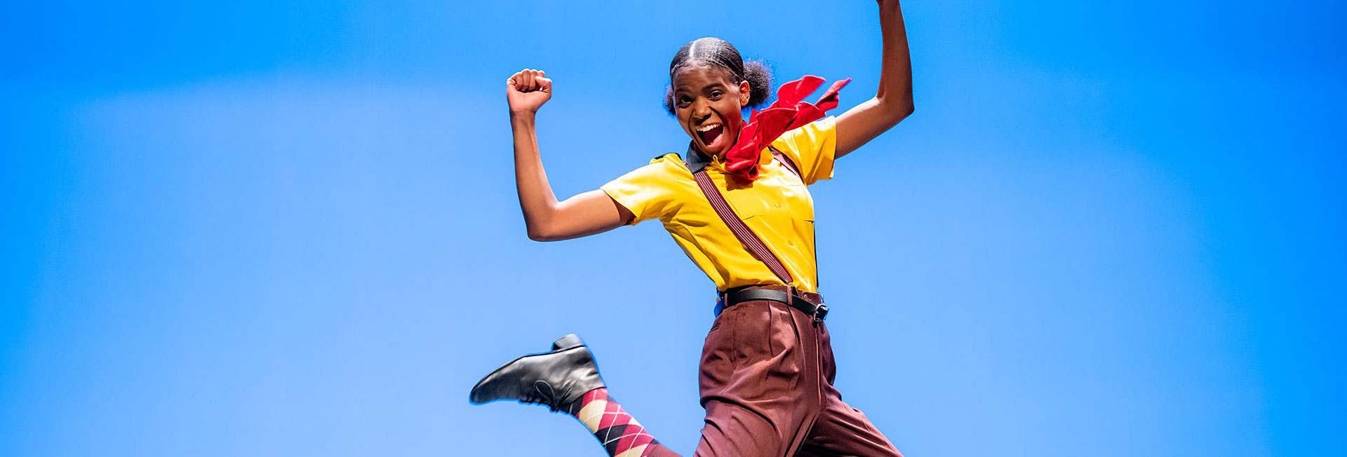 girl dressed as spongebob jumping in air 