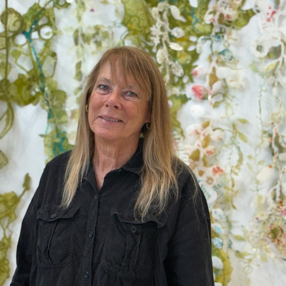 woman standing in front of greenery