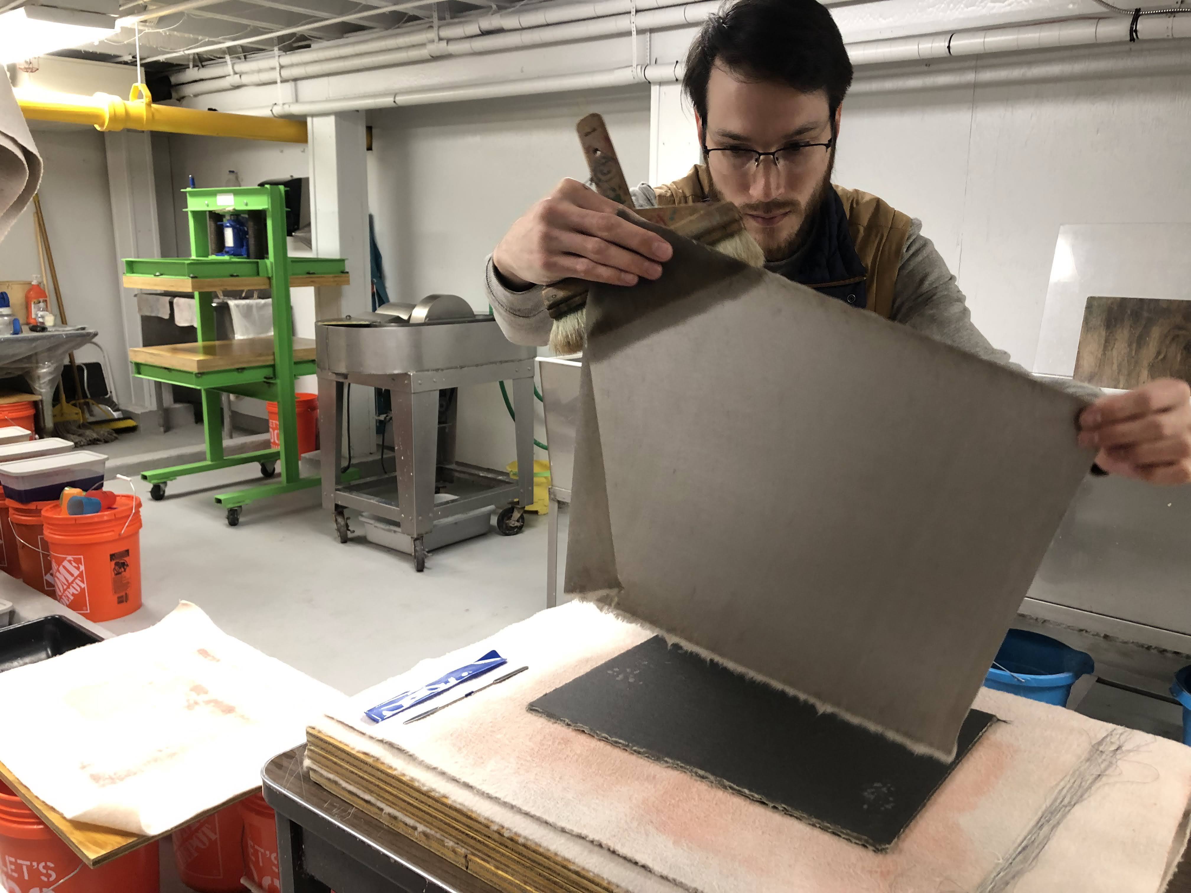 man holding up a piece of paper