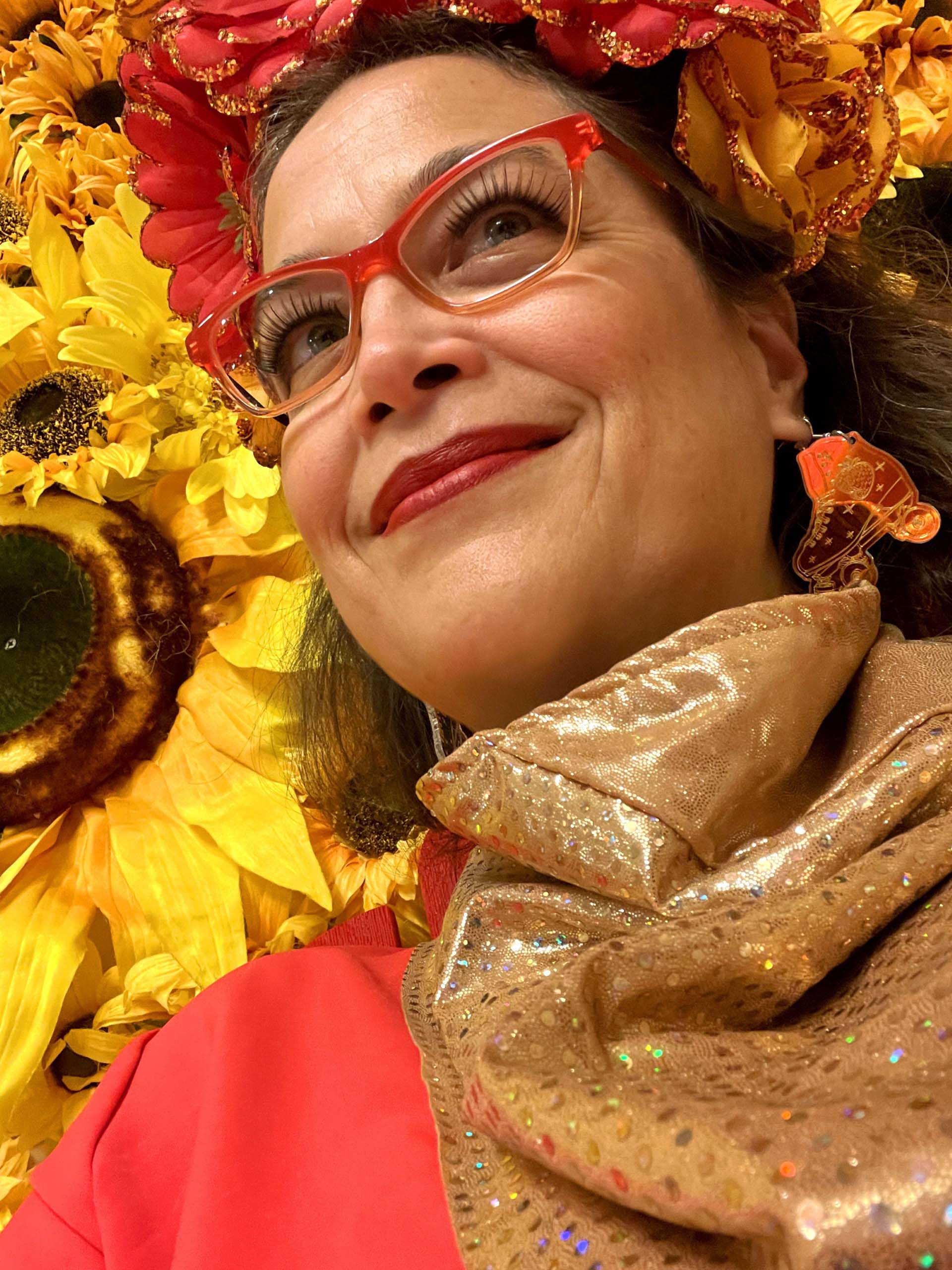 photo of artist in front of flowers