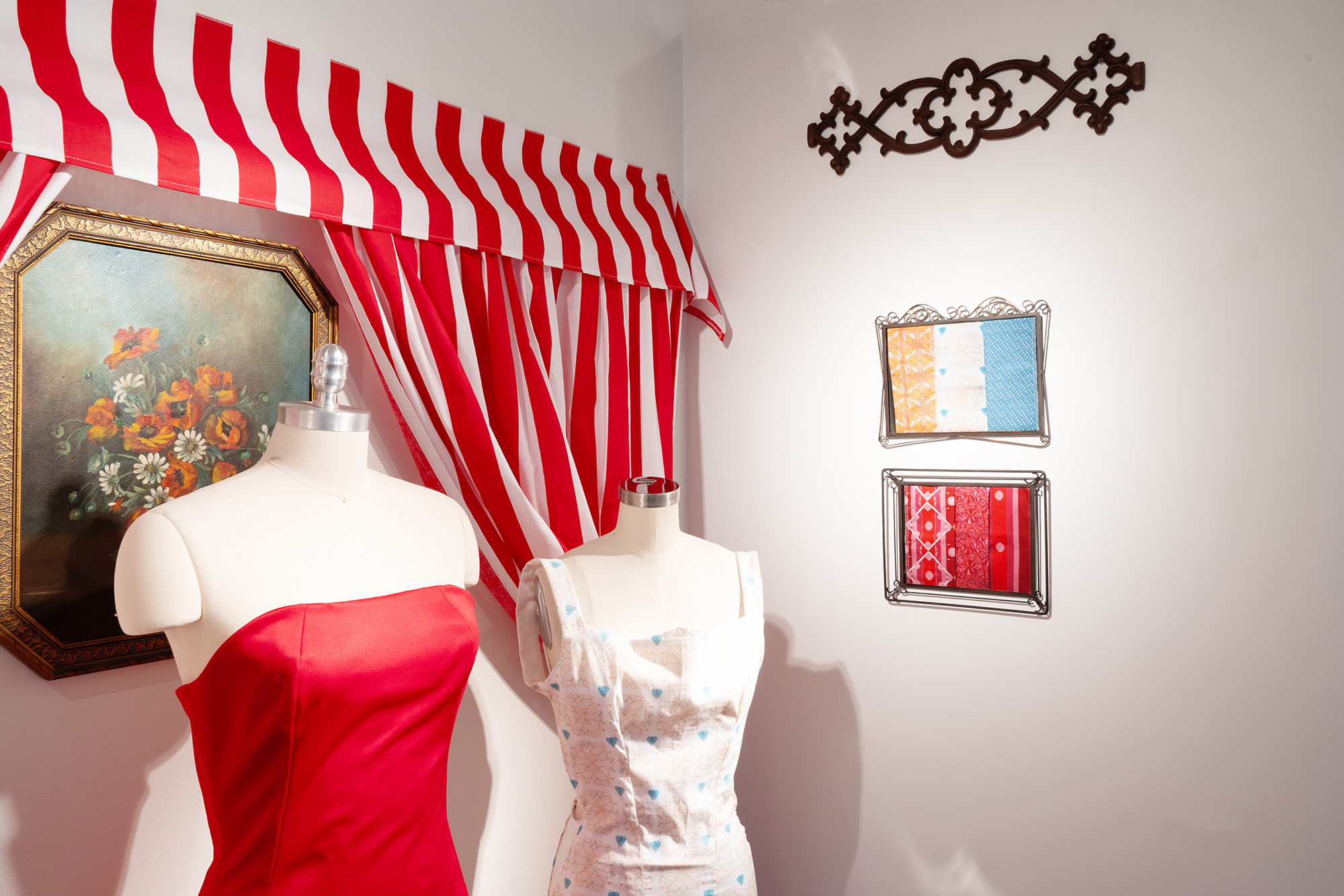 installation of textile works along a white wall