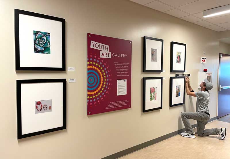 Photo of the Youth Art Gallery with man installing work