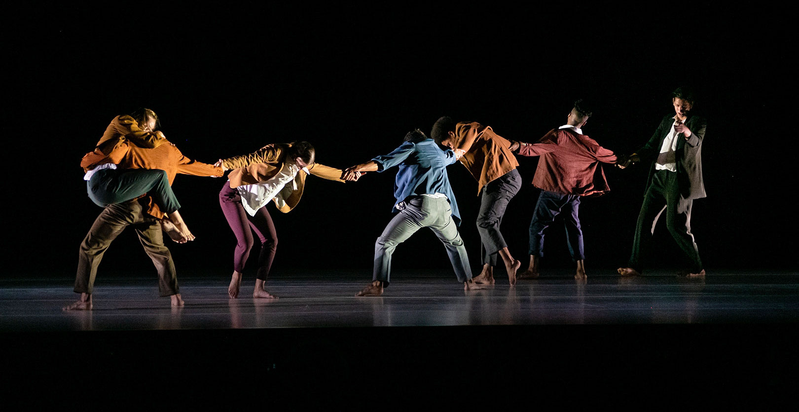 image of dancers on stage holding hands