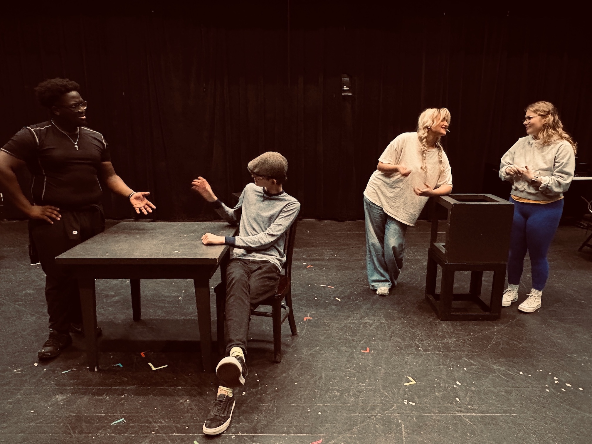 four students rehearse a play in class