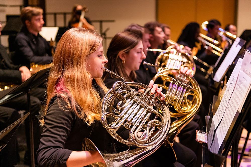 image of female musician playing French horn